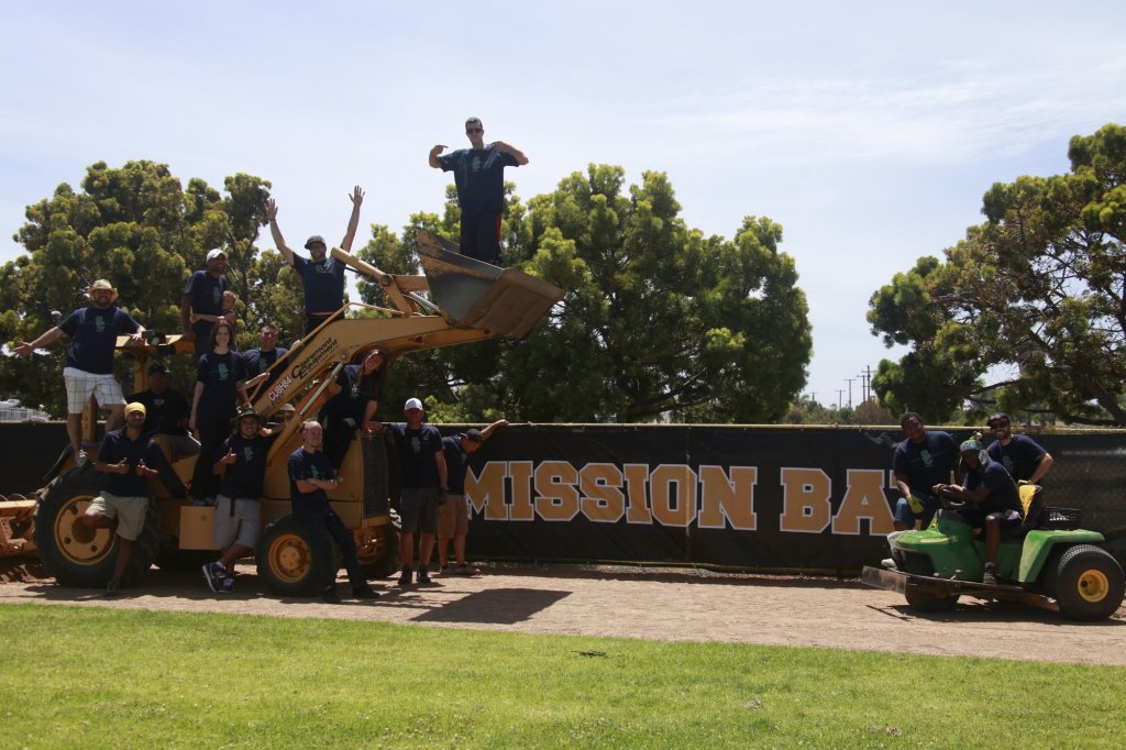 Second Chance Fields volunteers with heavy equipment during a baseball field renovation at Mission Bay in San Diego